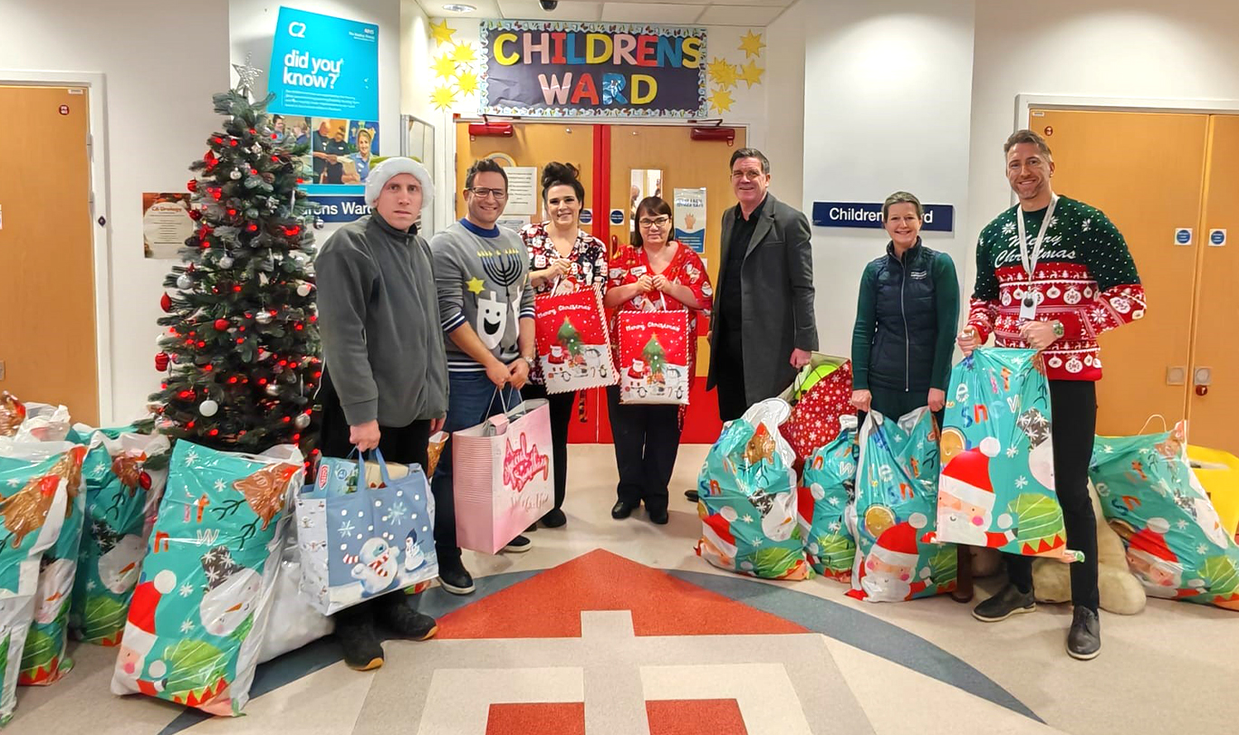 Nuttall Partners Carl Fallows, Dan Vangeen, Matt Hornblower, Suzanne Ward and Tim Parkes are pictured delivering gifts donated through its Christmas Gift Tag Appeal to Russells Hall Hospital in Dudley for children staying over the festive period